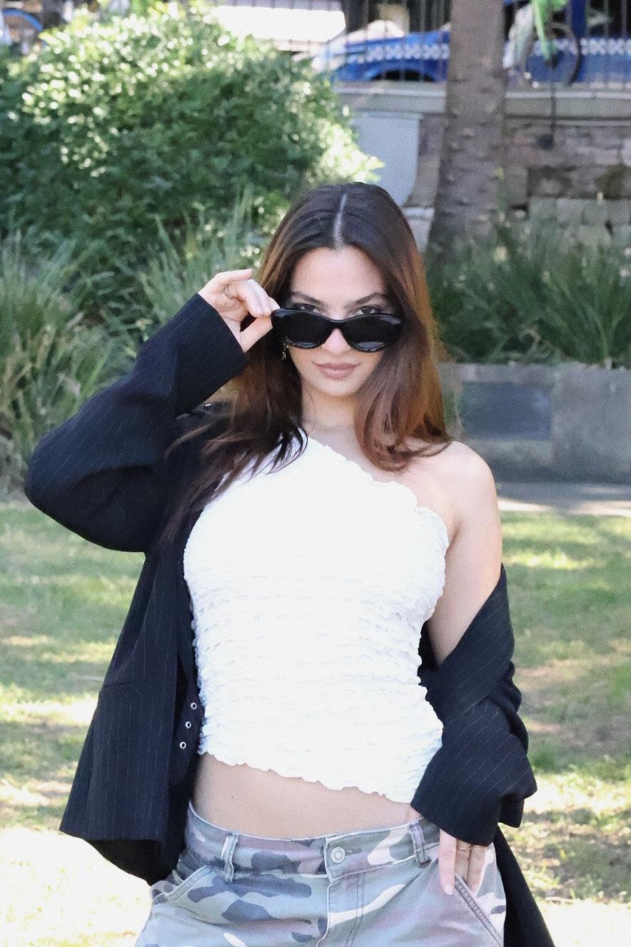 Stylish unisex cat-eye sunglasses by By Charley, featuring a black frame and polarized lenses that offer 100% UV protection and glare reduction for a confident, retro-inspired statement.