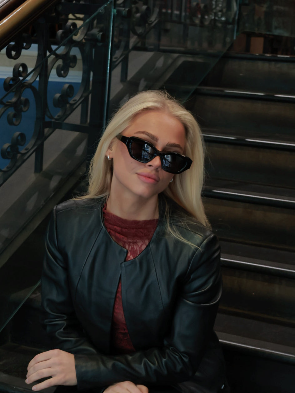 Stylish unisex polarized cat-eye sunglasses by By Charley, featuring a classic black frame that offers 100% UV protection and glare reduction for a bold, vintage-inspired aesthetic.
