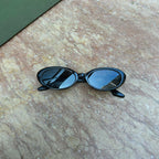 Embrace a fun vintage vibe with these By Charley unisex oval sunglasses in black with polarized lenses for a playful retro look.