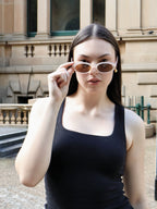 Stylish unisex oval sunglasses by By Charley, featuring a cinnamon frame and polarized lenses that provide 100% UV protection and glare reduction for a unique, fashion-forward accessory.

