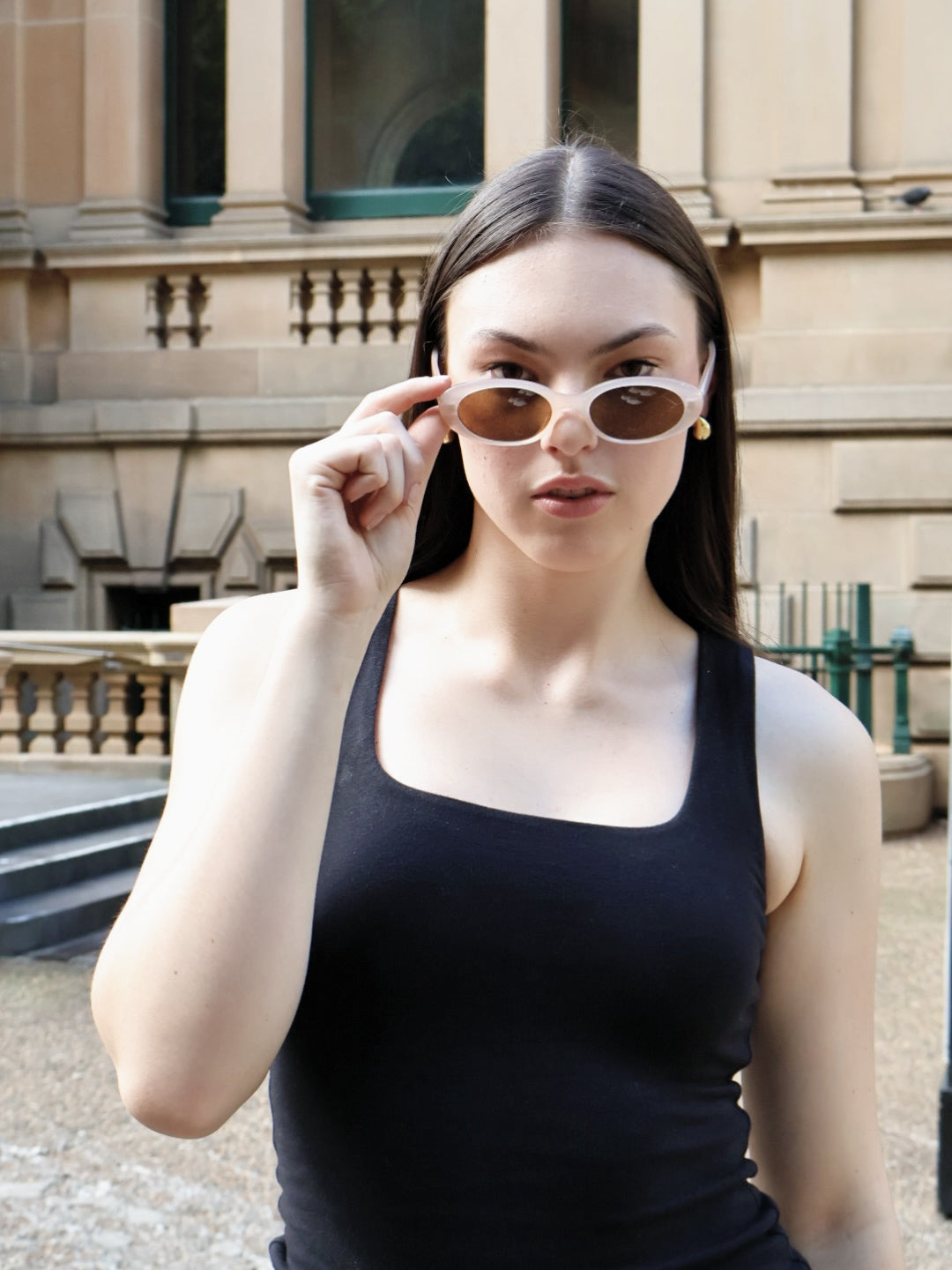 Stylish unisex oval sunglasses by By Charley, featuring a cinnamon frame and polarized lenses that provide 100% UV protection and glare reduction for a unique, fashion-forward accessory.

