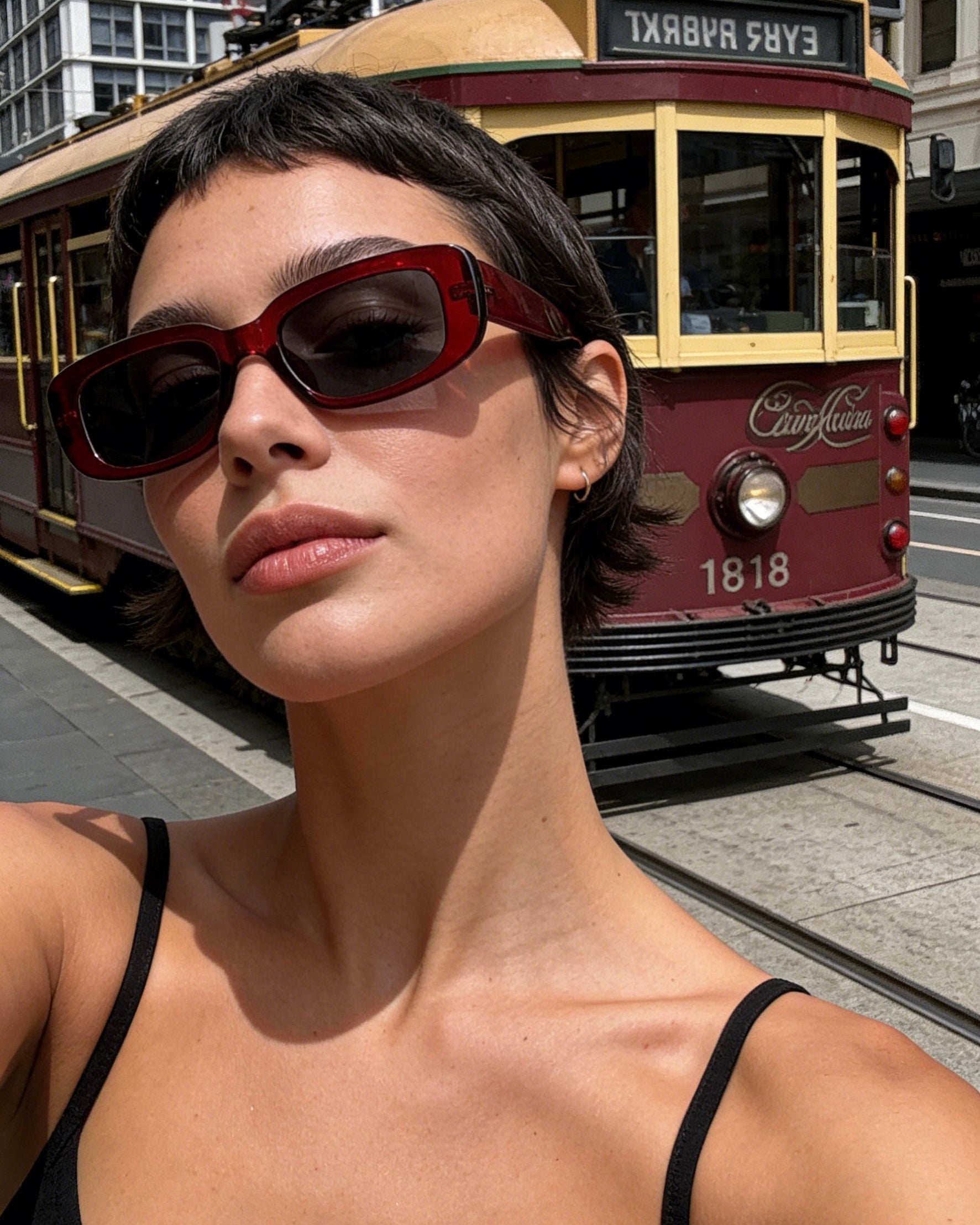 Red polarized rectangle sunglasses for women, UV400 protective lenses, chic summer eyewear accessory.
