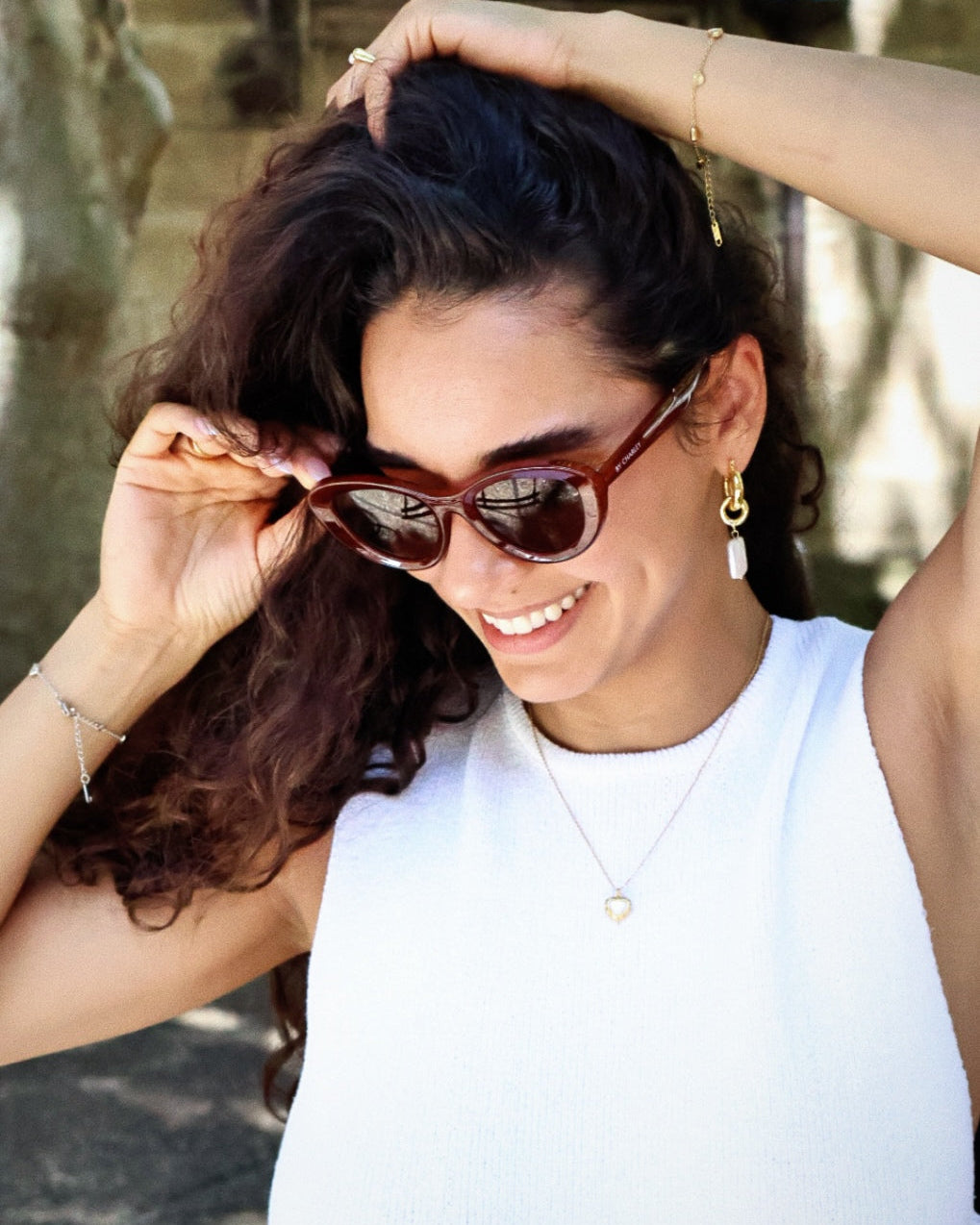 Bold black cat-eye sunglasses with thick frames, polarized lenses with UV protection, retro aesthetic eyewear for women. Brown wood grain pattern cat-eye sunglasses with tea-tinted polarized lenses and UV protection, vintage organic style eyewear.