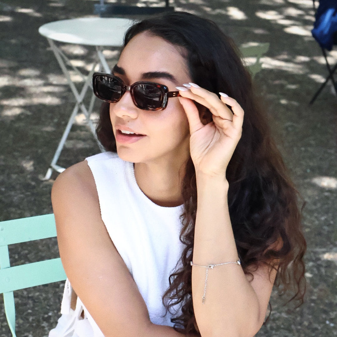 Stylish unisex square sunglasses by By Charley, featuring a classic tortoiseshell frame and polarized lenses that provide 100% UV protection and glare reduction for a confident, architectural aesthetic.