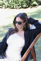 Stylish unisex cat-eye sunglasses by By Charley, featuring a black frame and polarized lenses that offer 100% UV protection and glare reduction for a confident, retro-inspired statement.