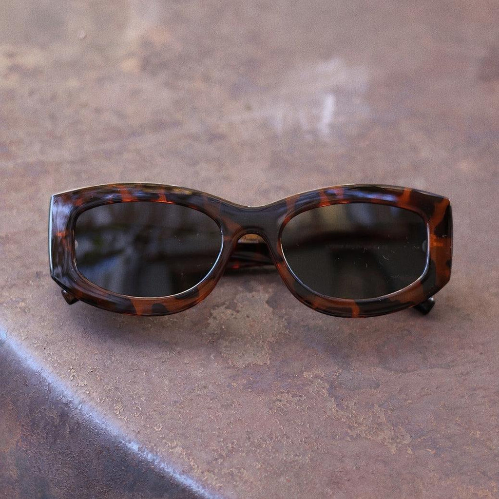 Bold unisex square sunglasses by By Charley, featuring a chunky tortoiseshell frame and polarized lenses that provide 100% UV protection and anti-glare functionality for a confident, architectural aesthetic.