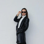 Embrace a playful and dramatic retro vibe with these By Charley unisex black cat-eye sunglasses featuring polarized lenses.