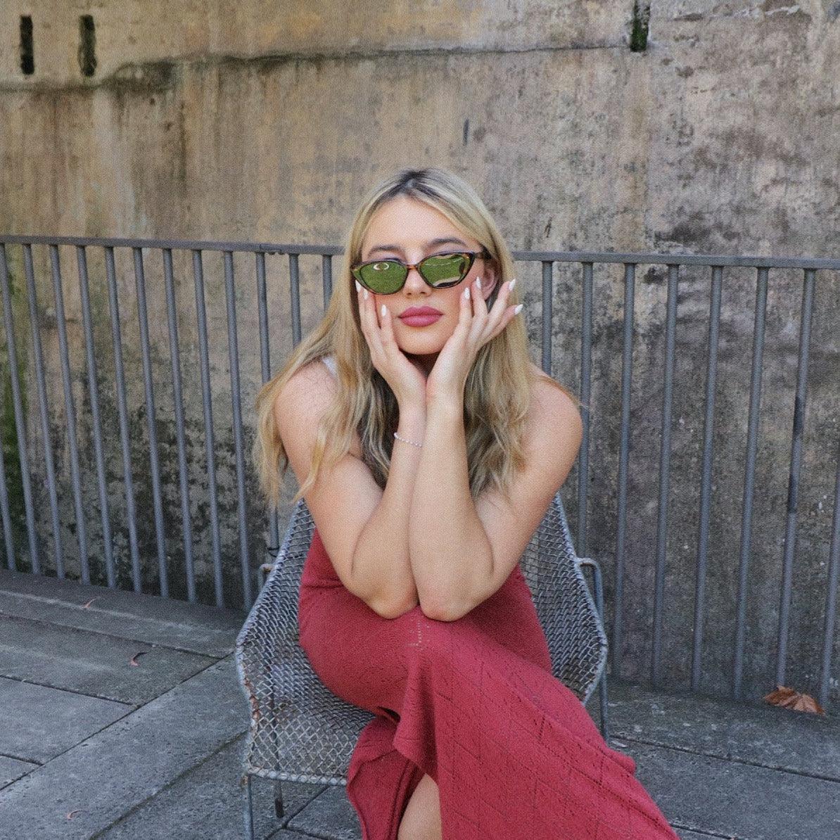 Playful unisex cat-eye sunglasses by By Charley, featuring a classic tortoiseshell frame and polarized lenses that offer 100% UV protection and glare reduction for a dramatic, retro-inspired statement.