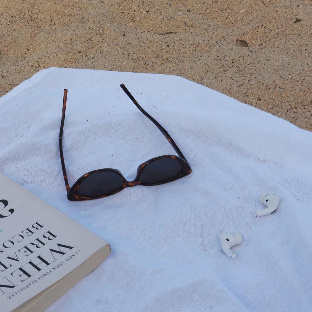 Playful unisex cat-eye sunglasses by By Charley, featuring a classic tortoiseshell frame and polarized lenses that offer 100% UV protection and glare reduction for a dramatic, retro-inspired statement.