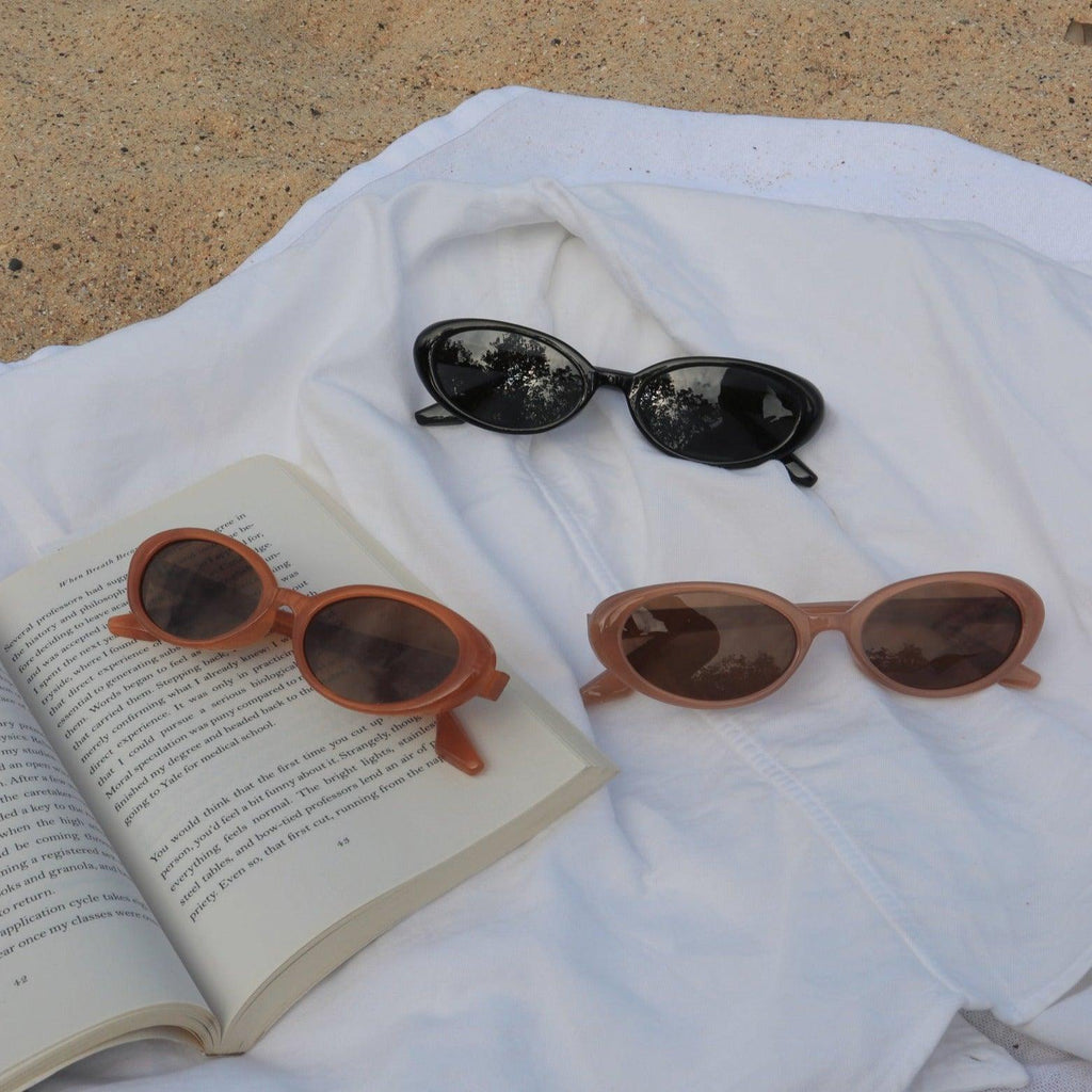 Make a unique statement with these playful oval sunglasses from By Charley. The retro unisex design in a warm pumpkin color features polarized lenses for all-day comfort.