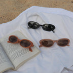 Make a unique statement with these playful oval sunglasses from By Charley. The retro unisex design in a warm pumpkin color features polarized lenses for all-day comfort.